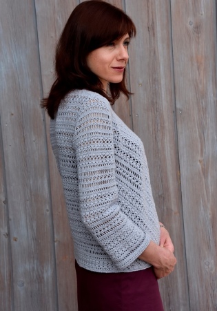 Crochet pattern for sizes XS-XL. Features diagonal patterns in front, three quarter sleeves and button at neckline. 