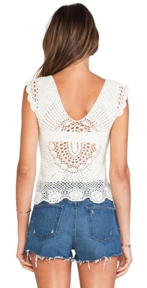 This crochet top is an effortlessly sweet style that will lend a boho feel to your look. The bottom is decorated with beautiful floral motifs, while a bow at the neckline adds a girly touch. 